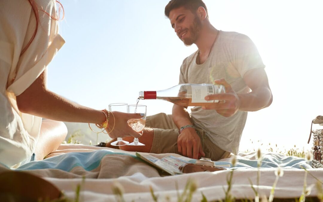 Pouring wine at picnic