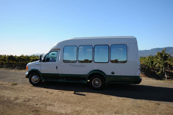 tour bus with vineyards behind