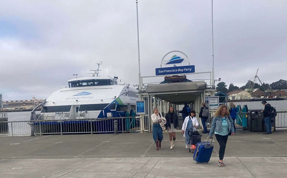 people walking off a ferry at a ferry terminal