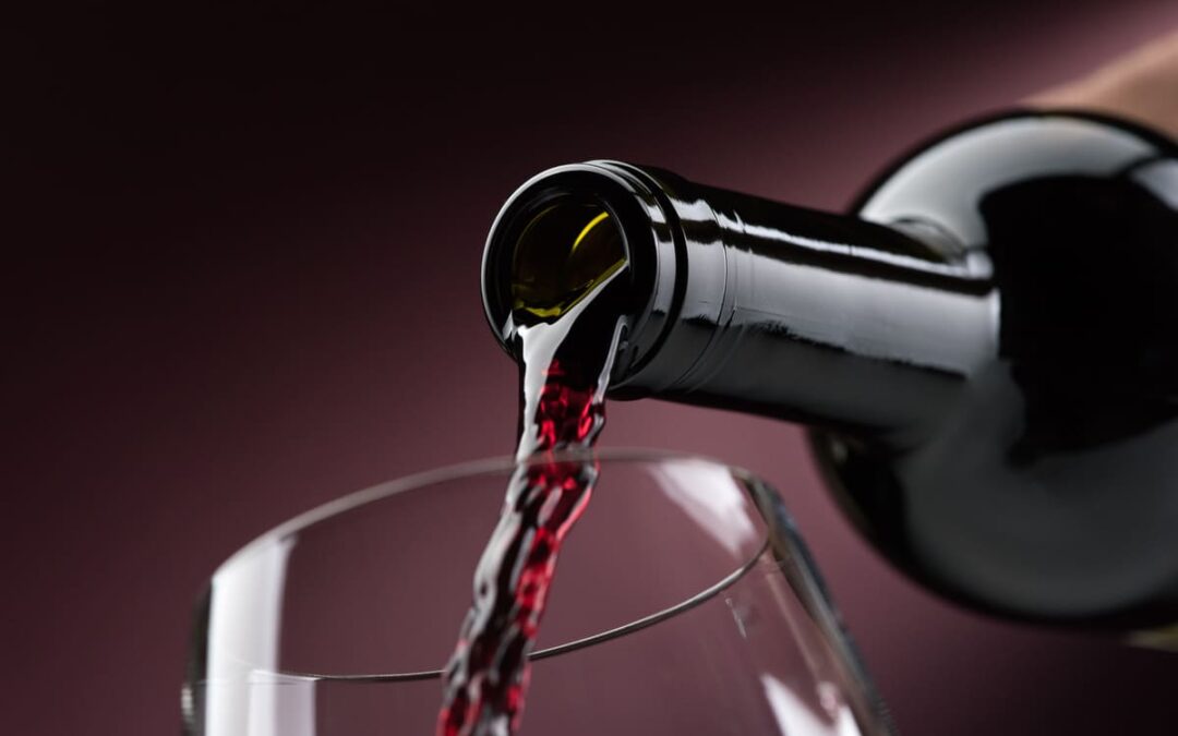 red wine being poured into a glass