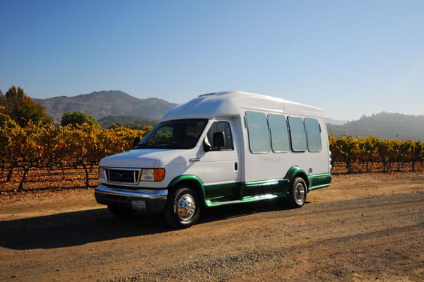 tour bus with vineyards behind