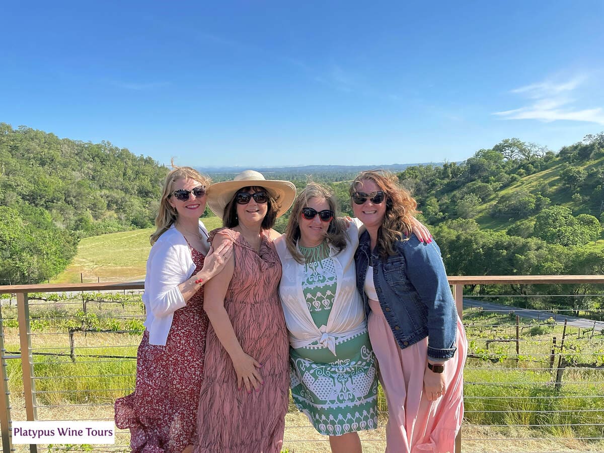 woman standing together with vineyards behind