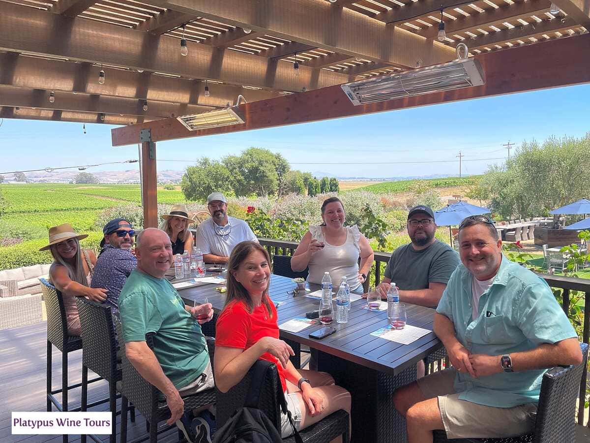 Group of people sitting around tasting wine