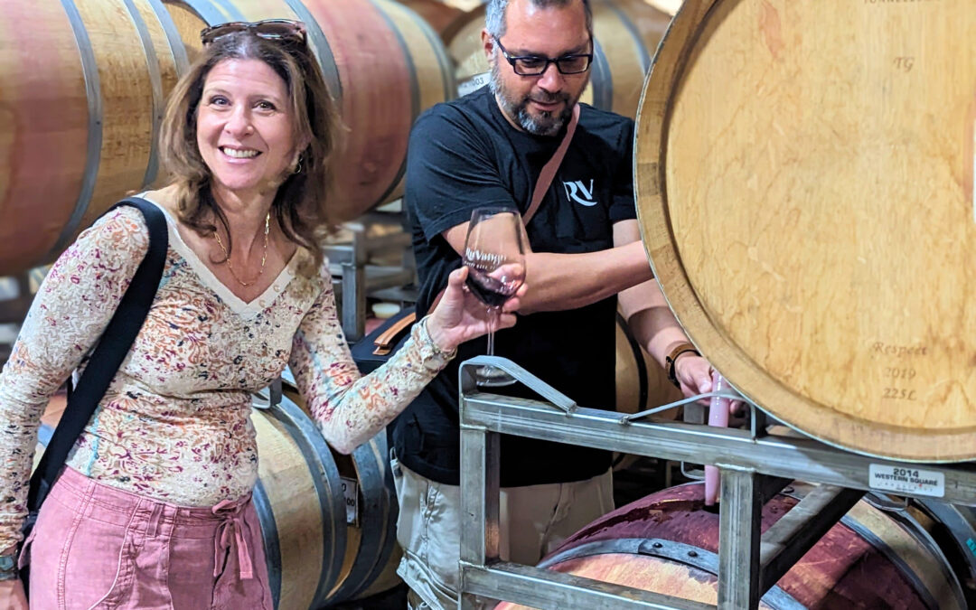 Behind-the-scenes winery experience in Napa Valley as a visitor samples wine directly from the barrel with a host.