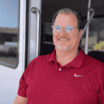 Platypus Tours guide Jason smiling at the doorway of a tour bus